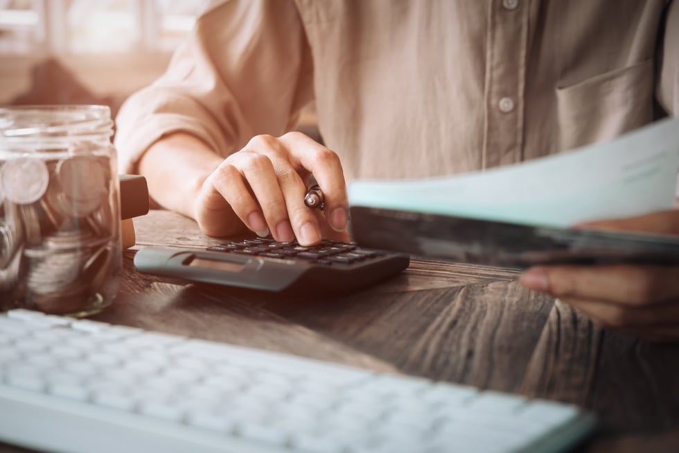 Woman Using a Calculator to Calculate 